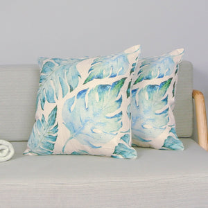 Aqua palm print outdoor cushion covers on a couch