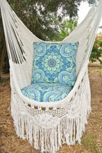 Closeup of the Byron white hanging chair outdoors