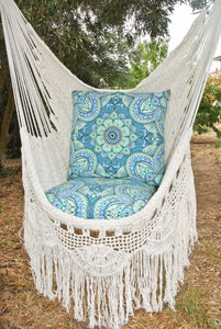 Closeup of the Byron white hanging chair outdoors