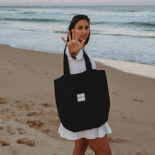 Model on beach with black tote bag plain