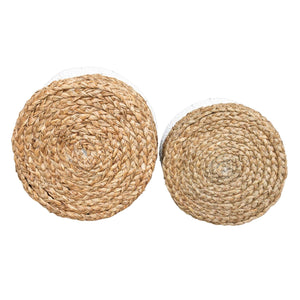 Bottom view of the set of two white and natural round wide baskets.  Handmade from plaited mendong grass