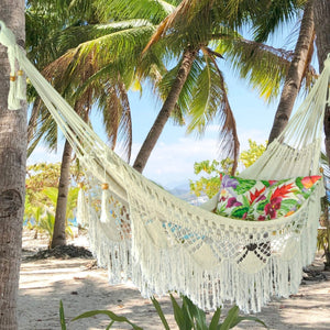 Styled byron white hammock hung between two trees on the beach
