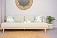 Couch with aqua palm print outdoor cushion covers
