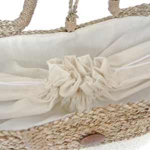 Drawstring in the lining of the white basket beach bag