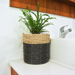 Medium size mixed small black basket on a bathroom vanity bench