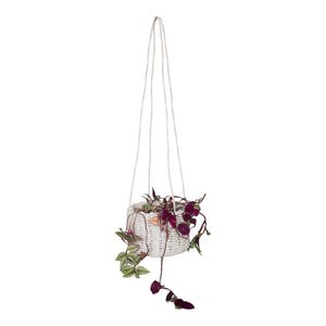 Full view white pandanus hanging basket holding a purple plant