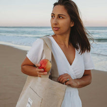 Model on beach with the beige tote bag canvas