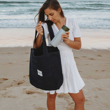 Model using black tote bag canvas