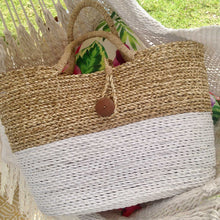 White basket handbag sitting on bed